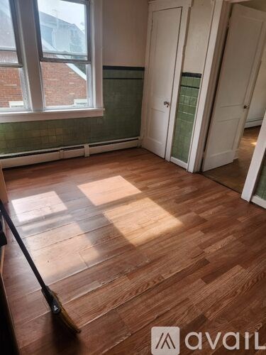 A room with wooden floors and a window.