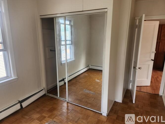 A room with a sliding door and wooden flooring.