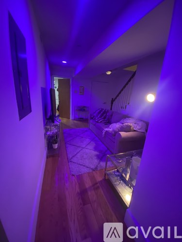 A living room with a couch and a television.