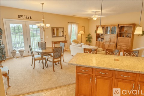 A living room with a dining table and chairs.