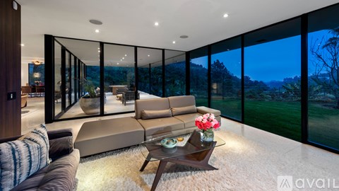 A modern living room with a large couch and a coffee table.
