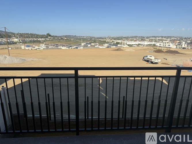 A construction site is visible from a balcony.