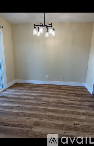A room with wooden flooring and a light fixture.
