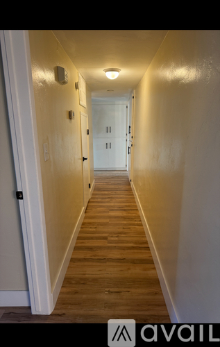 A long hallway with doors on both sides.