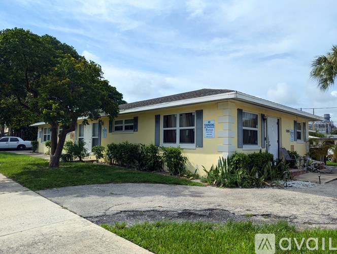 A yellow house with a sign that says "available" in front of it.