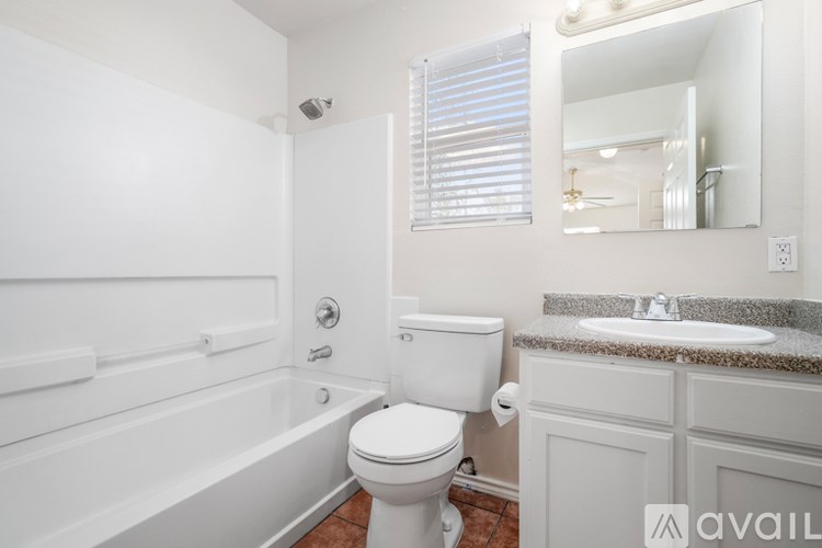 A bathroom with a toilet, sink, and bathtub.