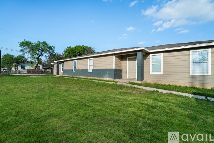 A row of houses with a grassy area in front.