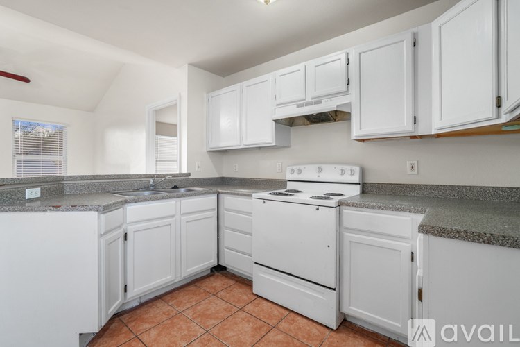 A kitchen with white appliances and cabinets.