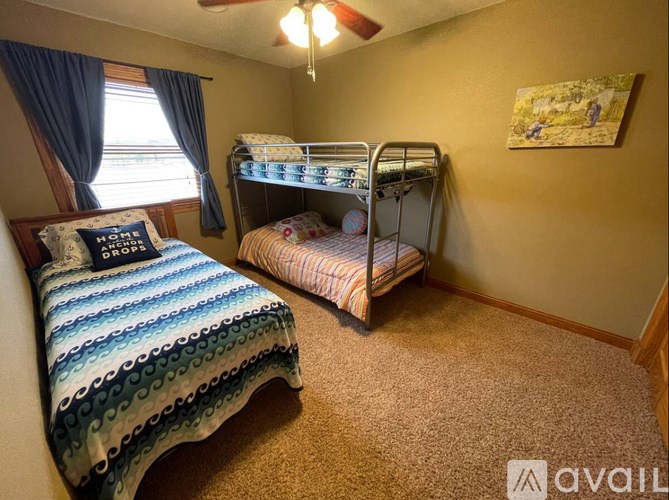 A bedroom with a bed and a bunk bed.