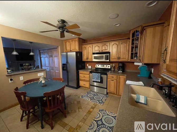 A kitchen with a table and chairs in the middle of the room.