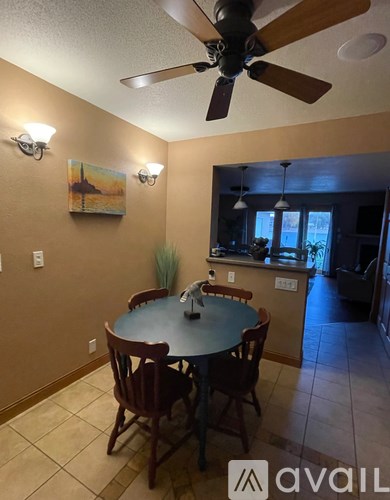 A dining room with a table and chairs.