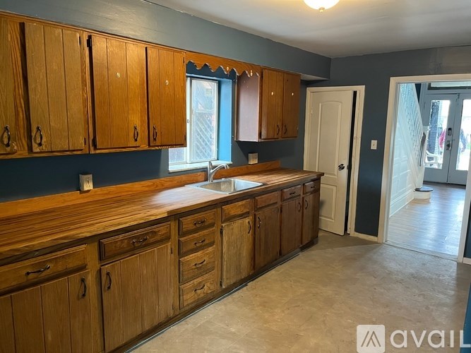 A kitchen with wooden cabinets and a sink.