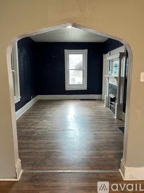 A room with wooden floors and a window.