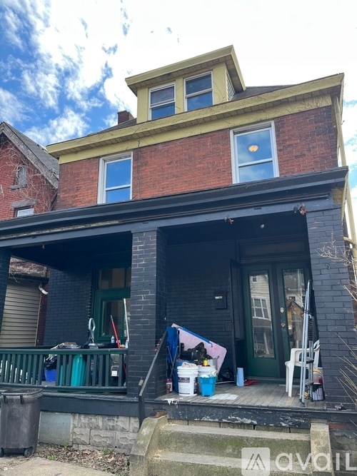 A house with a blue door and a green railing.