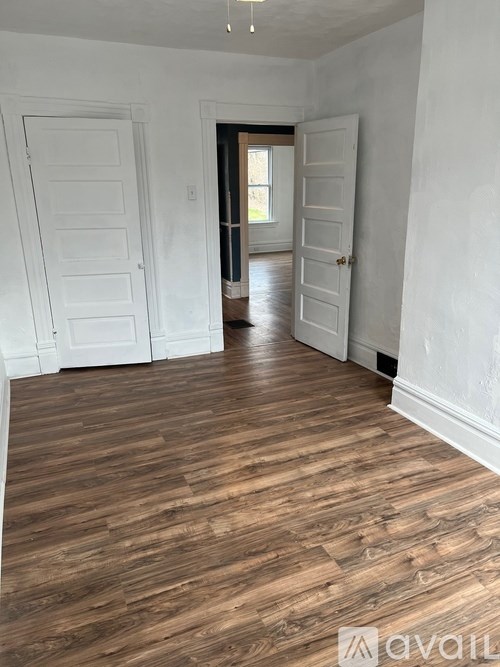A room with wooden floors and white walls.