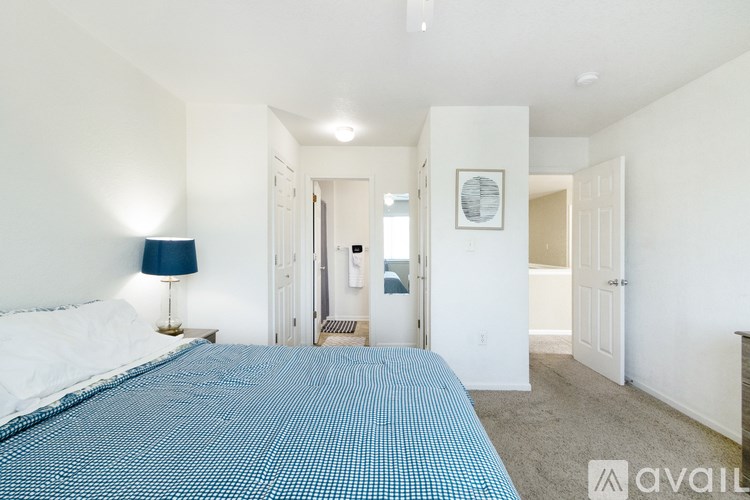 A bedroom with a bed and a lamp.