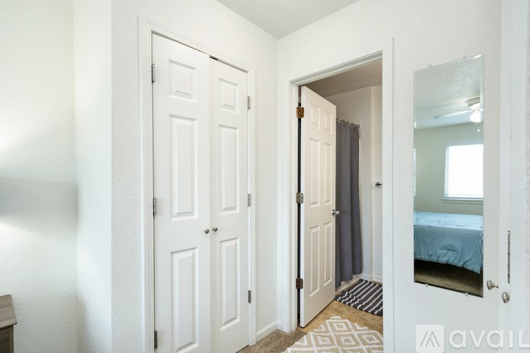 A bedroom with a bed, a dresser, and a mirror.