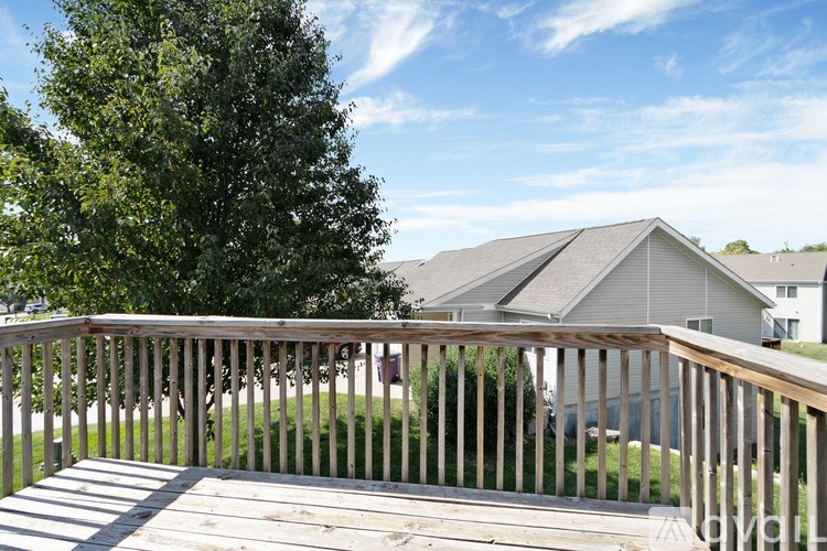 A wooden deck overlooks a residential area.