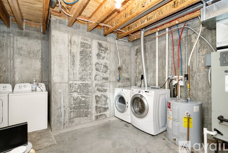 A laundry room with washers and dryers.