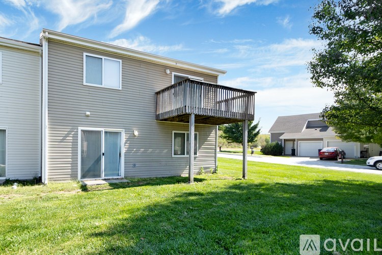 A two-story house with a balcony on the upper floor.