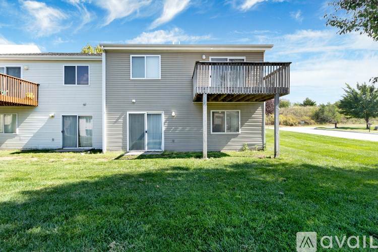 A two-story apartment building with a balcony on the second floor.
