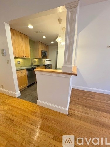A kitchen with wooden cabinets and a white counter.