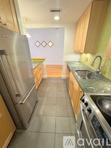 A kitchen with a stainless steel refrigerator and oven.