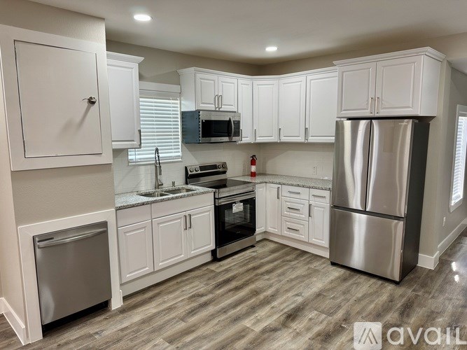 A kitchen with white cabinets and stainless steel appliances.