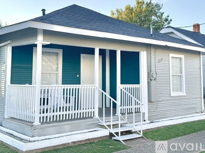 A room with a ceiling fan and wooden flooring.