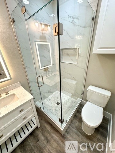 A room with a ceiling fan and two windows with blinds.