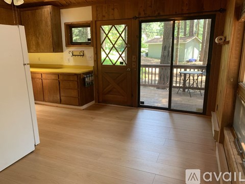 A kitchen with wooden cabinets and a white refrigerator.