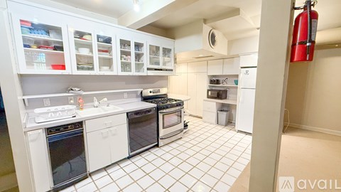 A kitchen with white appliances and cabinets.