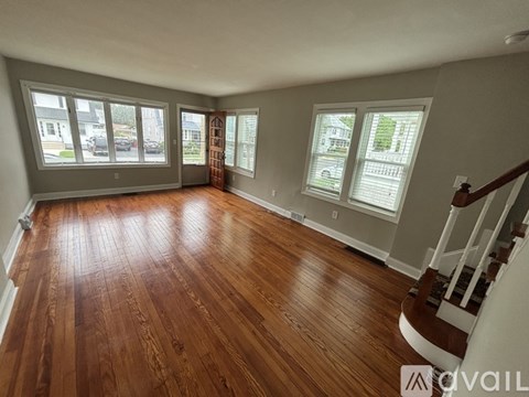 A room with wooden floors and a staircase.