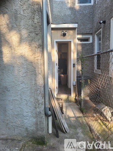 A small doorway is open to a dark interior.