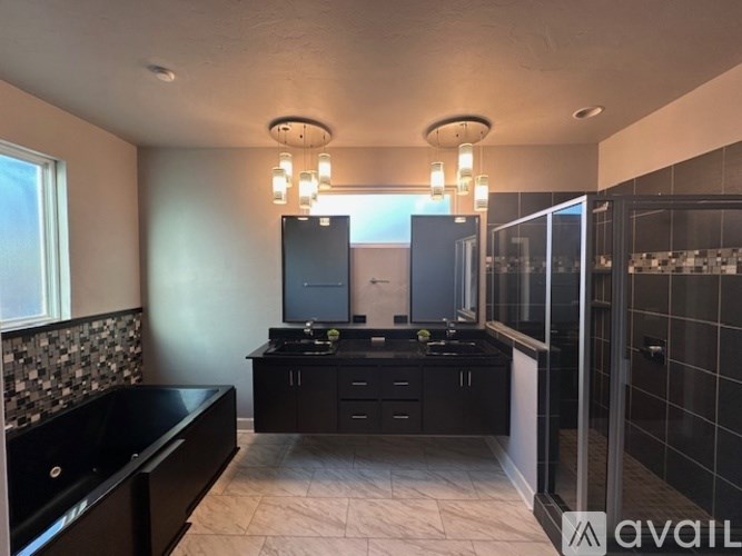 A modern kitchen with black cabinets and a black countertop.
