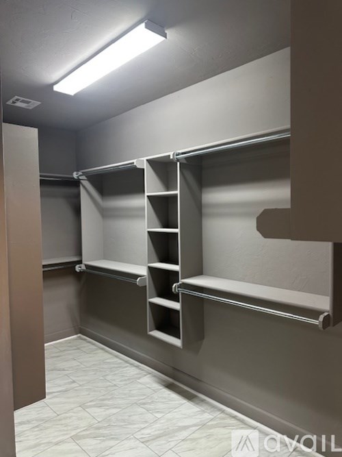 Closet with shelves and a door.