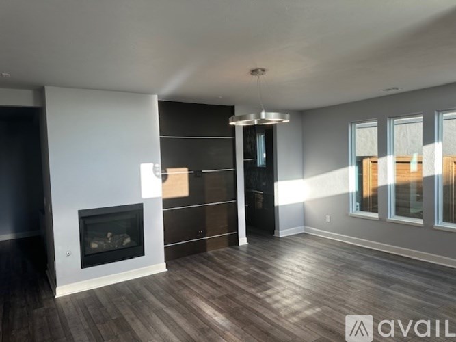A modern living room with a fireplace and wooden floors.