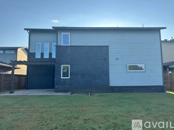 A modern house with a grey and black exterior is available for rent.