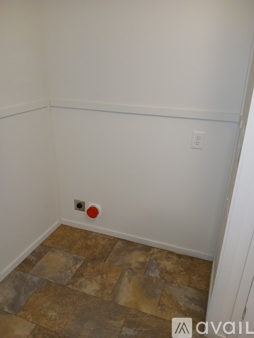 A room with a tile floor and a red object on it.