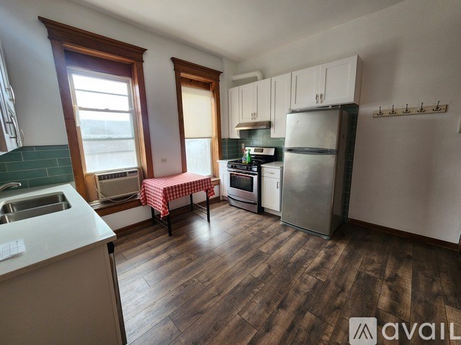 A kitchen with wooden floors and white appliances.