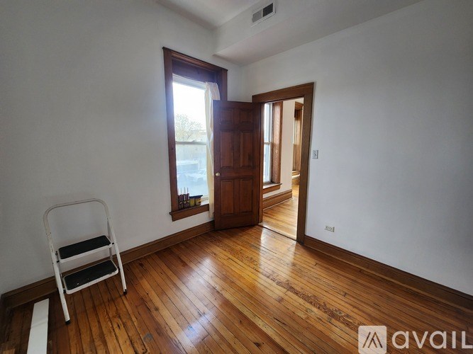 A bathroom with a tub, toilet, sink and mirror.