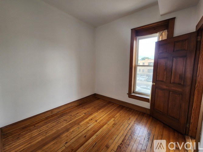 A room with wooden floors and a window.