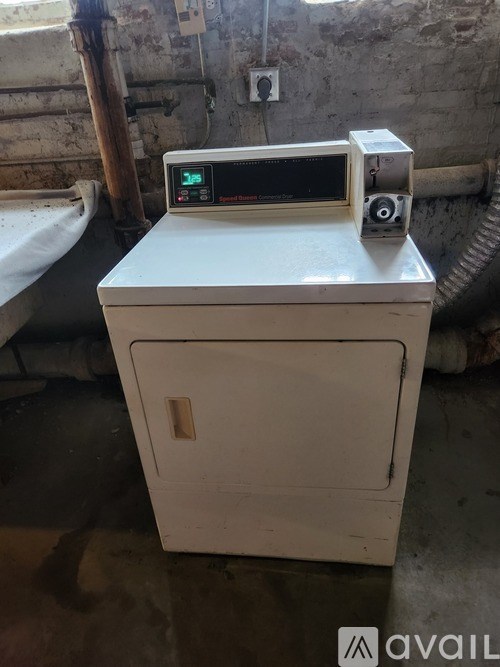 A machine with a digital display is placed on a white cabinet.