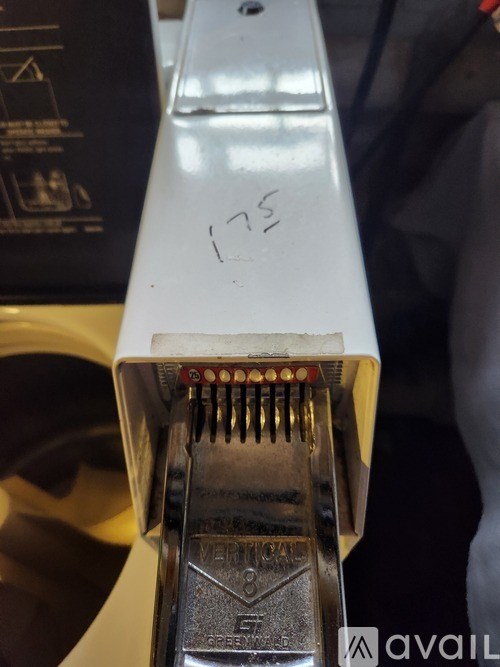 A close up of a white guitar with the number 175 written on it.