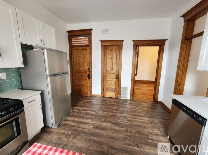A kitchen with a refrigerator, stove, and oven.