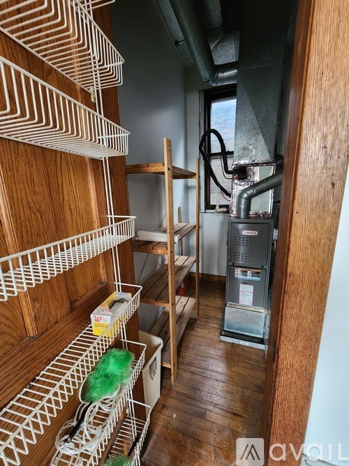 A room with a wood panel wall and a metal shelving unit.