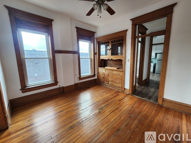 A room with wooden floors and white walls.