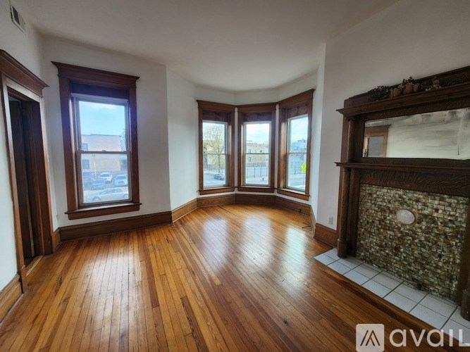 A room with wooden floors and a ceiling fan.