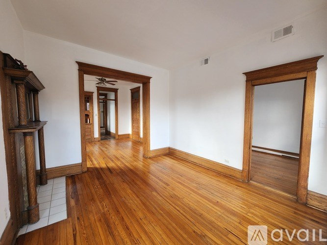 A room with wooden floors and a fireplace.