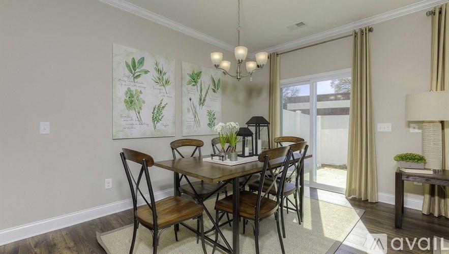 A dining room with a table set for four.